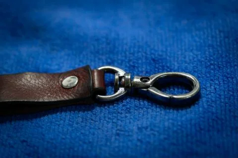 A Select focus Leather key chain with box on blue fabric background Stock Photos