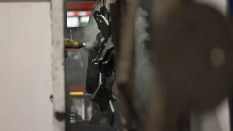 Select focus slo mo: Steel parts on hooks sprayed with power coat paint 스톡 동영상 306953922