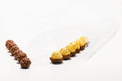 Select focus of wrapped and unwrapped chocolate and hazelnut sweets. Chocolat Stock Photos