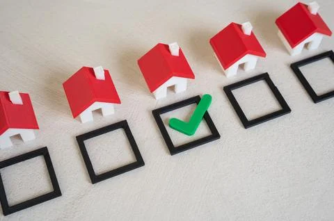 Select a house and mark it with a green check mark. Verified property, idea.. Stock Photos