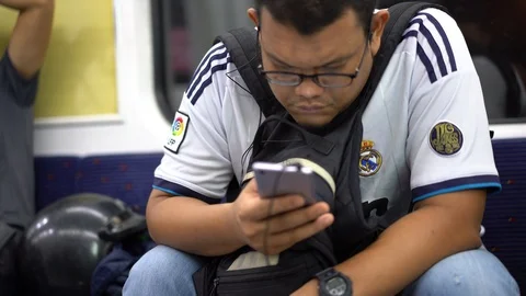 Selected focus on an asian man looking at the mobile phone Video stock 110988911