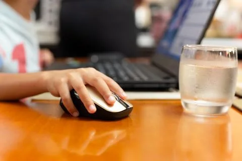 Selected focus childrens hand using laptop computer mouse Stock Photos