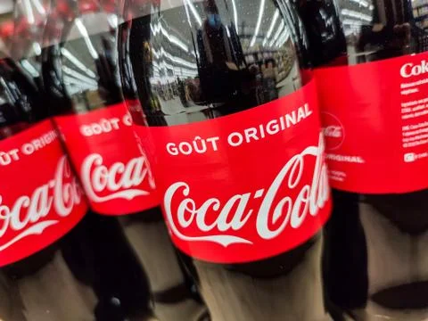 Selected Focus on a collection of Coca cola soft drink bottle's in french mar Stock Photos