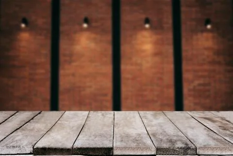 Selected focus empty wooden table and wall texture or old brick wall blur bac Stock Photos