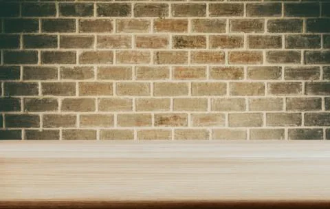 Selected focus empty wooden table and wall texture or old brick wall blur bac Stock Photos