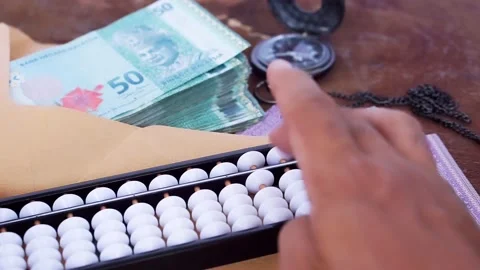 Selected focus: Hands are counting money using abacus. Stock Footage 142748153