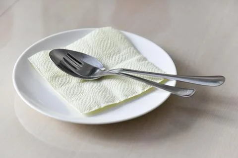 Selected focus on the served white dish with fork and spoon Stock Photos