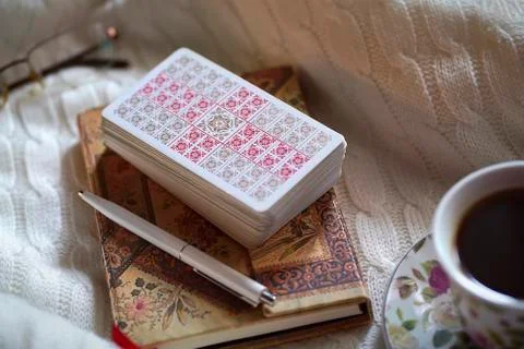 Selected focus of tarot cards layout, cup of Coffee and notebook. Stock Photos