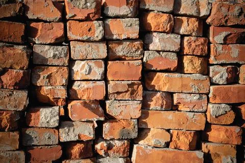 Selected red bricks for further use. Waste from a destroyed building. Stock Photos