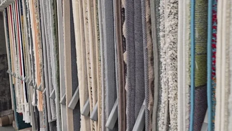 Selecting carpets in a specialized section of a store Stock Footage 342027633