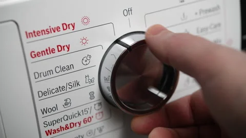 Selecting drying settings on a modern washing machine control panel Stock Footage 305078307