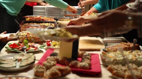 Selecting food at a potluck table Stock Footage 170653852