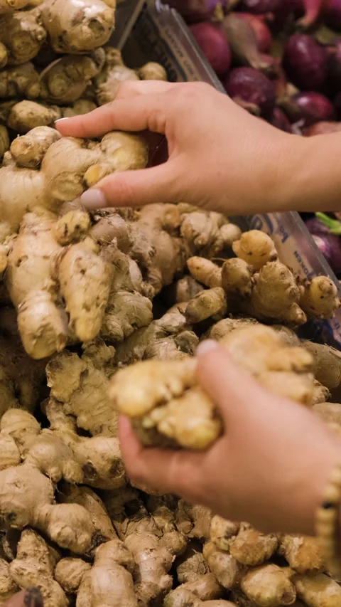 Selecting fresh ginger root at local store Stock Footage 315487393