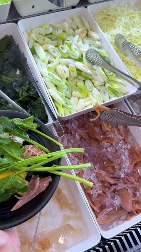 Selecting Fresh Pickled Squid and Vegetables at a Thai Shabu Buffet Stock Footage 335357374