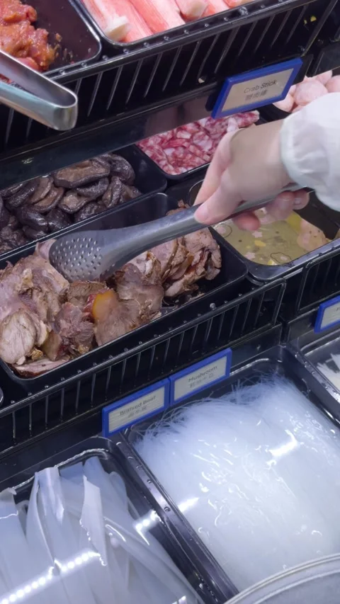 Selecting Hot Pot Ingredients at Buffet Counter Stock Footage 323493548