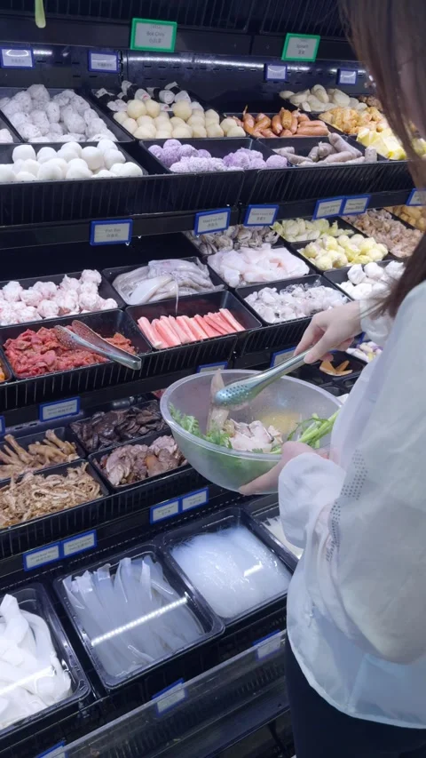 Selecting Hot Pot Ingredients at Buffet Counter Stockbeeldmateriaal 323493552