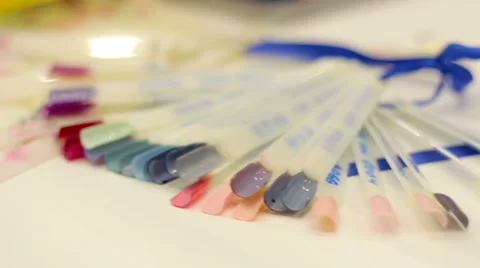 Selecting a manicure example in a beauty salon Stock Footage 58960884
