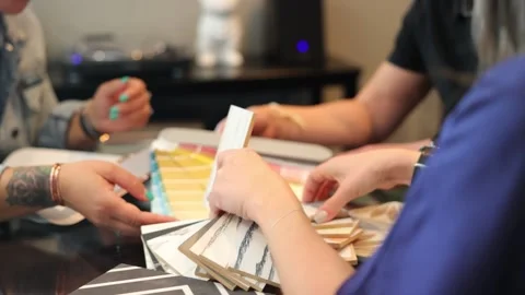 Selecting paint samples with a paint vendor for home improvement. Video stock 228582409