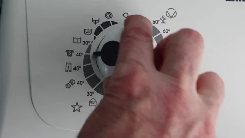 Selecting prewash on program selector dial of control panel of washing machine. Video stock 235185398