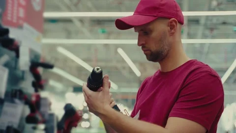 Selecting the right screwdriver in a hardware store during a weekend visit Stock Footage 293673674