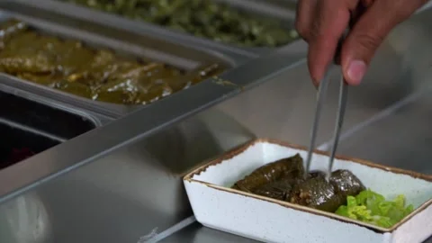 Selecting Stuffed Grape Leaves Video stock 318310233
