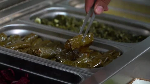 Selecting Stuffed Grape Leaves Stock Footage 318310240