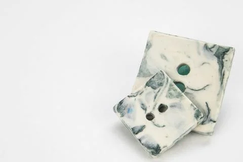 Selection of artisan handmade ceramic buttons isolated on a white background. Stock Photos