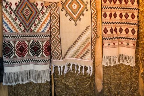 Selection of authentic carpets on hayricks Stock Photos