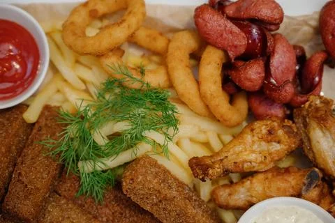 Selection of beer and snacks.Chips, fish, beer sausages on the table Stock Photos