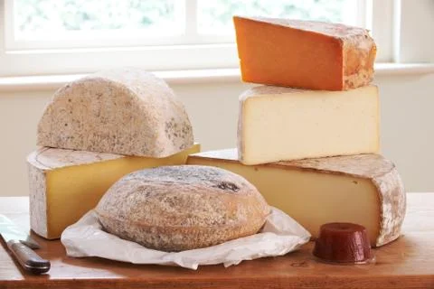 Selection Of Cheese On Board With Knife Stock Photos