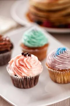 Selection of Colored Cupcakes on a Plate. High quality photo. Stock Photos