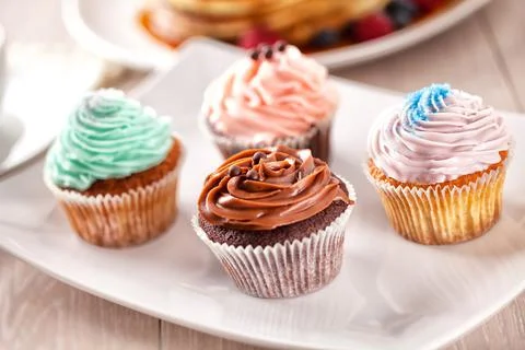 Selection of Colored Cupcakes on a Plate. High quality photo. Stock Photos
