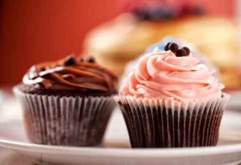 Selection of Colored Cupcakes on a Plate. High quality photo. Stock Photos
