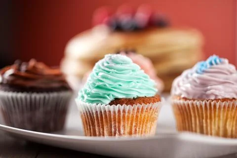 Selection of Colored Cupcakes on a Plate. High quality photo. Stock Photos