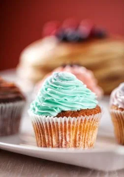 Selection of Colored Cupcakes on a Plate. High quality photo. Stock Photos