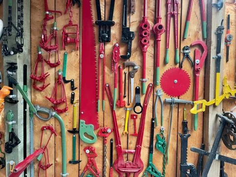 A selection of colourful hand tools displayed on a handyman's workshop wall Stock Photos