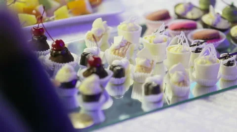 Selection of decorative desserts on a buffet table at a catered luxury event or Stock Footage 64807869