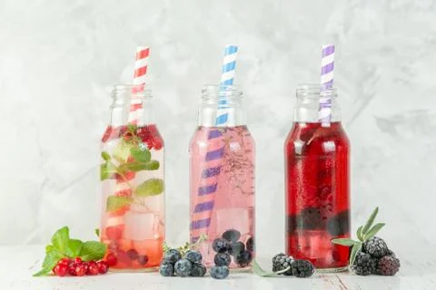 Selection of different drinking vinegars - berries with herbs Stock Photos