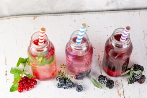 Selection of different drinking vinegars - berries with herbs Stock Photos
