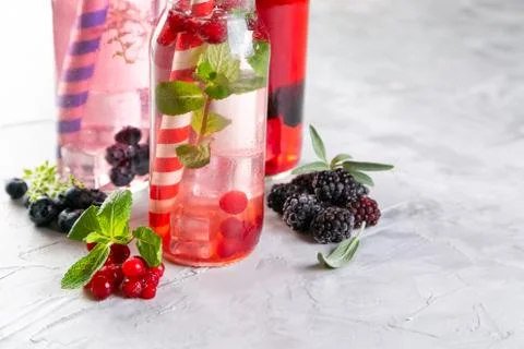 Selection of different drinking vinegars - berries with herbs Stock Photos
