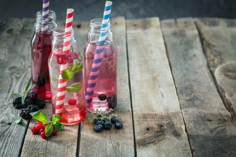 Selection of different drinking vinegars - berries with herbs Stock Photos