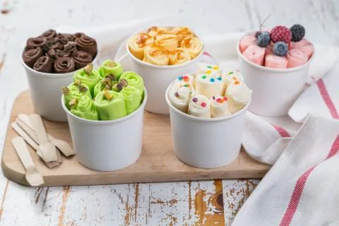Selection of different rolled ice creams in cone cups Stock Photos