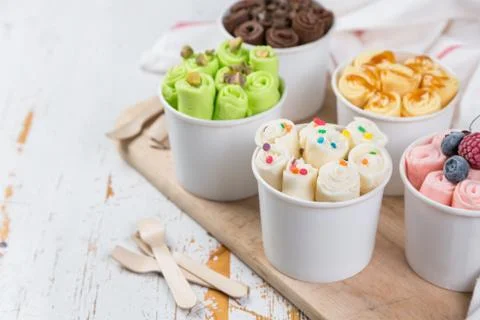 Selection of different rolled ice creams in cone cups Stock Photos