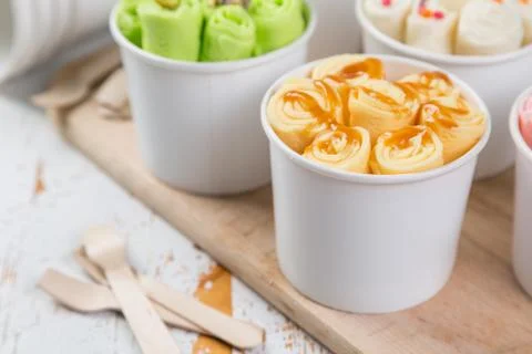 Selection of different rolled ice creams in cone cups Stock Photos