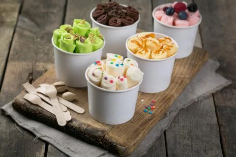 Selection of different rolled ice creams in cone cups Stock Photos
