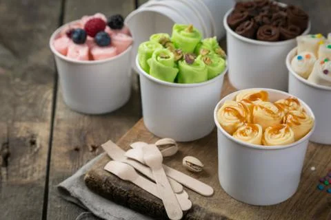 Selection of different rolled ice creams in cone cups Stock Photos