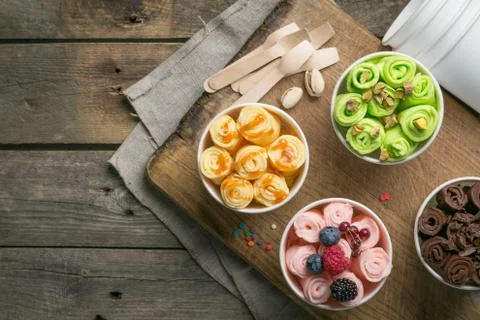 Selection of different rolled ice creams in cone cups Stock Photos