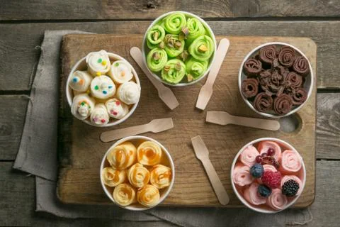 Selection of different rolled ice creams in cone cups Stock Photos