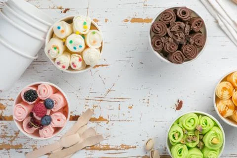 Selection of different rolled ice creams in cone cups Stock Photos