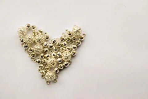 Selection of different silver beads shaped into a heart 스톡 사진